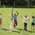People raising their weapons in a LARP competition