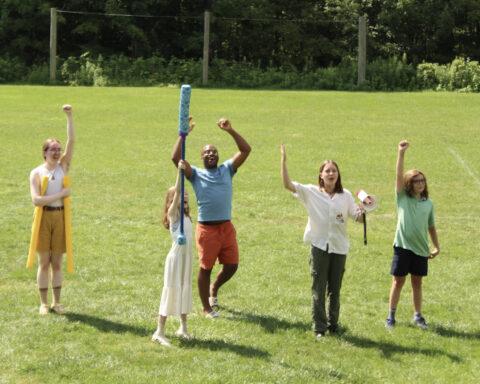 People raising their weapons in a LARP competition