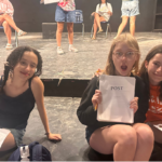 Child actors on stage reading scripts
