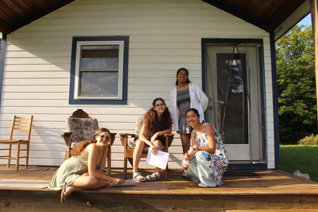 The band Mai Cumulus on a porch of a small house