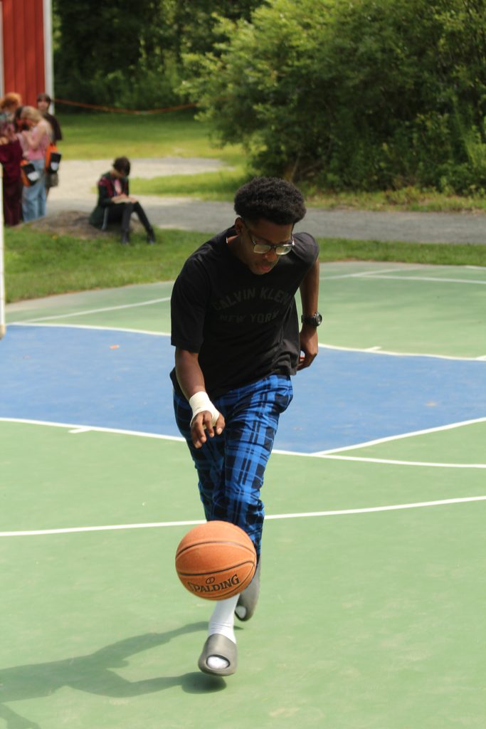 A camper dribbling a basketball